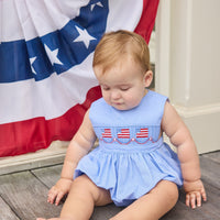 Little English traditional children's clothing. Sleeveless bubble in royal blue mini check fabric and smocking at the chest with American flag bunting for baby boys