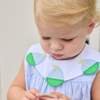 Little English traditional children's clothing. Light blue seersucker gingham bubble with white bib collar and applique sailboats for baby girls.