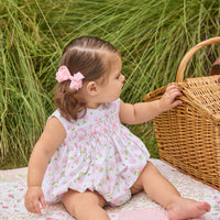 Little English traditional children's clothing. White sleeveless smocked bubble with pink and green florals for baby girls