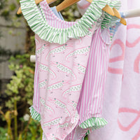 Little English traditional children's clothing. Pink swimsuit with green striped ruffled top and alligator pattern for little girls