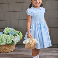 Little English classic smocked emery dress in light blue with white detailing, smocking around chest, tieable in back, for little girl