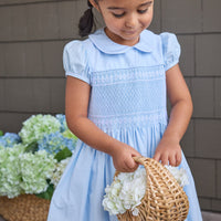 Little English classic smocked emery dress in light blue with white detailing, smocking around chest, tieable in back, for little girl
