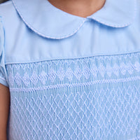 Little English classic smocked emery dress in light blue with white detailing, smocking around chest, tieable in back, for little girl