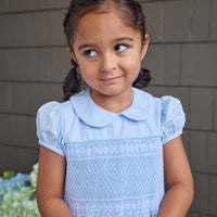 Little English classic smocked emery dress in light blue with white detailing, smocking around chest, tieable in back, for little girl