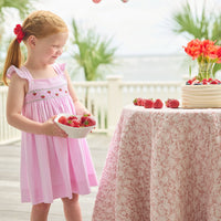 Little English traditional children's clothing. Light pink seersucker gingham dress for little girls with flutter sleeves and strawberry smocking across the chest