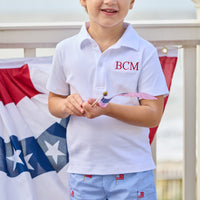 Little English traditional children's clothing. Blue gingham shorts with all-over American flag embroidery for boys. Boy's shorts for 4th of July.