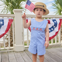 Little English traditional children's clothing. Classic john john for toddler boys in royal blue mini gingham with American flag smocking at the chest