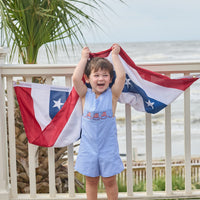 Little English traditional children's clothing. Classic john john for toddler boys in royal blue mini gingham with American flag smocking at the chest
