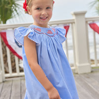 Little English traditional children's clothing. Flutter sleeve dress for toddler girls in royal blue mini gingham with smocking at the collar and American flag bunting