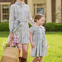 Little English traditional children's clothing. Capped sleeve blue, brown, and cream floral smocked dress with peter pan collar for little girls.