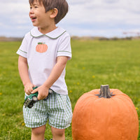 Little English classic short set for little boys. White knit peter pan shirt with applique pumpkin at the center and coordinating banded shorts in green Leland Plaid.