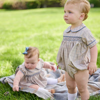 Little English classic children's clothing. Smocked peter pan bubble in tan and blue Durham windowpane with blue piping for baby boys