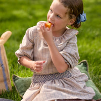 Little English traditional children's clothing. Long sleeve blouse in tan and blue Durham Windowpane with a ruffled collar paired with matching skirt with blue smocked waistband for girls