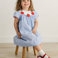 Little English traditional children's clothing. Short sleeve royal blue gingham dress with white bib collar with applique apples for little girls