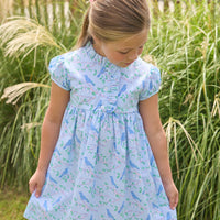 Little English traditional children's clothing. Light blue dress with blue bird and cherry blossom print for little girls