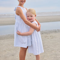 Little English traditional children's clothing. Light blue and white Savannah Stripe sleeveless dress with white bow tie in back for little girls