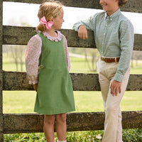 Little English traditional children's clothing. Green Watercress Gingham button down with tan Pebble Twill Classic Pants for boys. Watercress Green and pink floral long sleeve jumper set for girls.