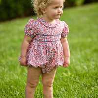 Little English traditional children's clothing. Soft blue and raspberry red Lennox Floral short sleeve bubble for baby girls with ruffle collar and blue piping detail at sleeves and chest