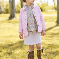 Little english classic childrens clothing, quilted jacket in light pink, hallie top in orange, blue, and green james floral, paperbag bow skirt in stone corduroy