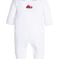Little English traditional children's clothing. White pima cotton footie with peter pan collar, navy polkadots and picot trim, and crocheted red firetruck at center of chest