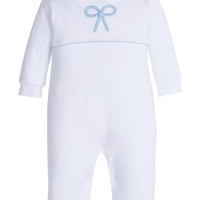 Little English traditional children's clothing. Baby girl's white knit peter pan playsuit romper with blue bow crochet for Spring. Gift clothing for baby girl