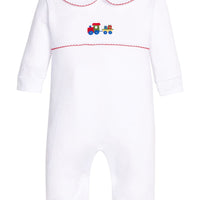 Little English traditional children's clothing. White pima cotton playsuit with peter pan collar, red picot trim, and crocheted holiday train at center of chest