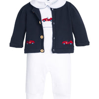 Little English traditional children's clothing. Navy blue cotton cardigan with crocheted red race cars on either side and in back for baby boys. Layered over white pima cotton playsuit with peter pan collar, navy picot trim, and race car crochet at center chest