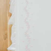 Little English classic nursery goods for baby, white crib sheet with simple light pink embroidery along the edges for baby