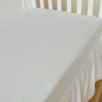 Little English classic nursery goods for baby, white crib sheet with simple light green embroidery along the edges for baby