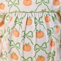 Little English classic play bubble for baby girls. Cream knit bubble with white peter pan collar and pumpkin and green bow print.