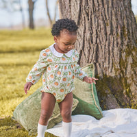 Little English classic play bubble for baby girls. Cream knit bubble with white peter pan collar and pumpkin and green bow print.