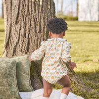 Little English classic play bubble for baby girls. Cream knit bubble with white peter pan collar and pumpkin and green bow print.