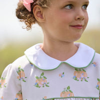 Little English traditional children's clothing. Long sleeve pumpkin floral print cotton knit dress with white peter pan collar and green piping detail for little girls.