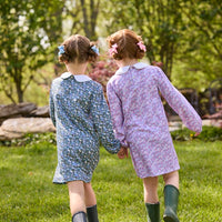 Little English traditional children's clothing. Long sleeve blue and green Winslow Floral cotton knit dress with white peter pan collar and blue piping detail for little girls. Long sleeve pink, blue, and lavender Ashbrook Floral cotton knit dress with white peter pan collar and pink piping detail.