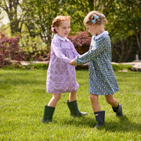 Little English traditional children's clothing. Long sleeve blue and green Winslow Floral cotton knit dress with white peter pan collar and blue piping detail for little girls. Long sleeve pink, blue, and lavender Ashbrook Floral cotton knit dress with white peter pan collar and pink piping detail.