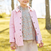 Little english classic childrens clothing, quilted jacket in light pink, hallie top in orange, blue, and green james floral, paperbag bow skirt in stone corduroy
