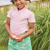 Little English traditional children's clothing. Classic green twill skort with golf cart print and pink trim for girls.