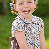 Little English traditional children's clothing. Short sleeve peter pan dress in blue, pink, and brown Wilmington Plaid with brown corduroy piping and bow details for little girls.