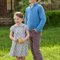 Little English traditional children's clothing. Boys stormy blue quarter zip sweater layered over blue, pink, and brown Wilmington Plaid button down shirt and paired with chocolate brown corduroy classic pants. Short sleeve peter pan dress in blue, pink, and brown Wilmington Plaid with brown corduroy details for little girls.