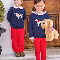 little english classic children's clothing boys navy sweater with cream lab motif, red piped peter pan shirt, and red banded corduroy pant. girls navy sweater with red bow on cream lab motif, smocked madeline blouse in red, and red leggings for fall