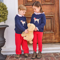 little english classic children's clothing boys navy sweater with cream lab motif, red piped peter pan shirt, and red banded corduroy pant. girls navy sweater with red bow on cream lab motif, smocked madeline blouse in red, and red leggings for fall