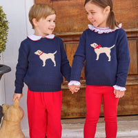 little english classic children's clothing boys navy sweater with cream lab motif, red piped peter pan shirt, and red banded corduroy pant. girls navy sweater with red bow on cream lab motif, smocked madeline blouse in red, and red leggings for fall