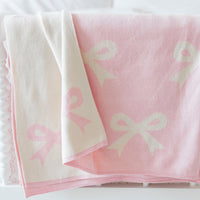 Little English giftable nursery accessory, reversible knit nursery blanket with light pink and cream bow print