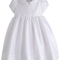 Little English traditional kids clothing. Girl's formal dress in white with peter pan collar and capped sleeves. Special occasion dress, traditional flower girl dress