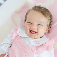 little english classic children's clothing baby girls light pink pointelle knit bubble with ruffle sleeve, pinpoint onesie with pink rocking horse motif. For baby girl