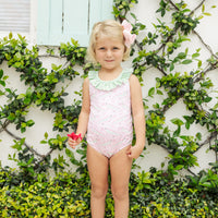 Little English traditional children's clothing. Pink swimsuit with green striped ruffled top and alligator pattern for little girls