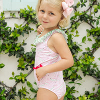Little English traditional children's clothing. Pink swimsuit with green striped ruffled top and alligator pattern for little girls