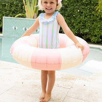 Little English traditional children's clothing. Pink, green, and blue striped swimsuit with blue ruffled top and for little girls