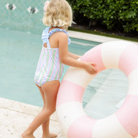 Little English traditional children's clothing. Pink, green, and blue striped swimsuit with blue ruffled top and for little girls