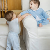 Little English traditional children's clothing. Set of 3 knit onesies in light blue stripe, light blue, and white with light blue stars. Baby jogger set in light blue. Pointelle knit set in light blue with peter pan picot onesie in white for baby boys.